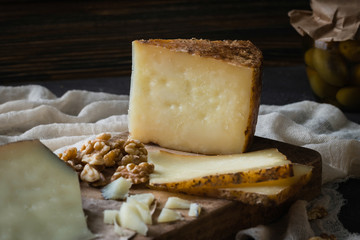 Cheese platter of chopped Spanish hard cheese manchego and sliced Italian pecorino toscano) on...