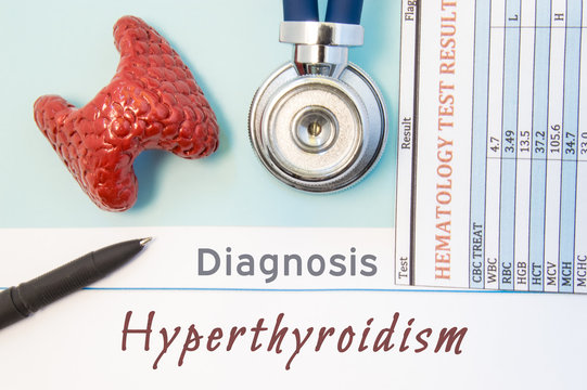 Endocrinology diagnosis Hyperthyroidism. Figure of thyroid gland, result of laboratory analysis of blood medical stethoscope and black pen lying near text inscriptions Hyperthyroidism doctor workplace