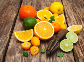 Fresh citrus fruits and old juicer