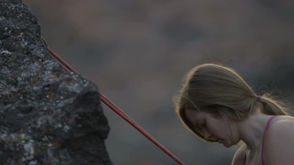 girl repels down rock