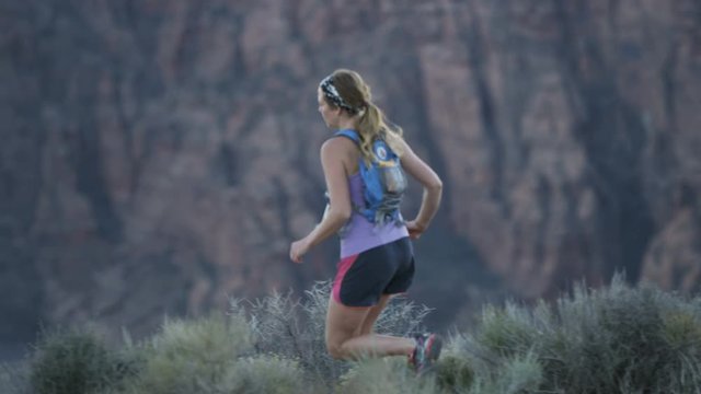 slow motion of girl trail running in desert in Southern Utah
