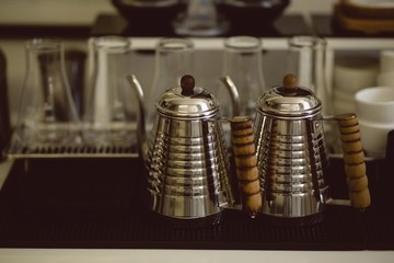 Metallic jugs on table