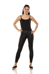 Fototapeta premium Whole figure of a young woman in tights and blouse