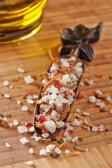 Large crystals of sea salt with dry herbs and pepper