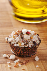 Large crystals of sea salt with dry herbs and pepper