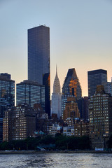 Fototapeta na wymiar Manhattan Midtown east skyline in sunset with a cloudless sky seen from Roosevelt Island