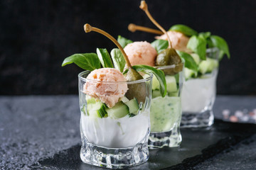 Verrines appetizer with salmon pate, red caviar, cucumber, cream cheese, herbs, capers in glasses...