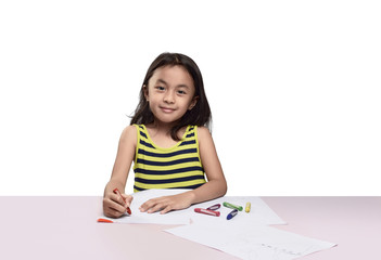 Cute asian little girl drawing with colorful crayon
