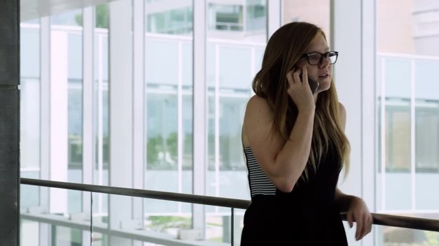 woman pacing while on the phone