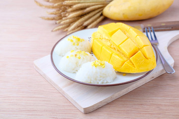 mango and sticky rice on wood background