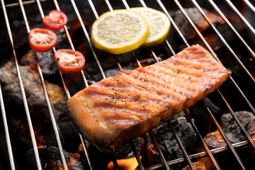 Grilled salmon with lemon on the flaming