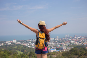 Brunette stands with arms raised