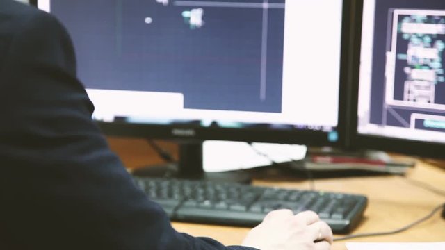 man work on computer with two monitors