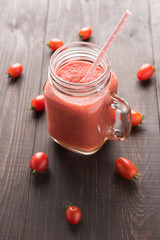 Healthy vegetable. Glass of red tomato juice on wooden table