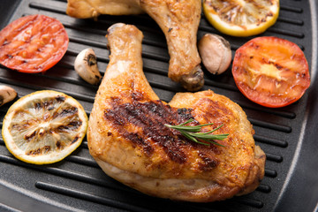 Grilled chicken lag and vegetables in a pan