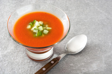 Traditional Spanish cold gazpacho soup on gray stone.
