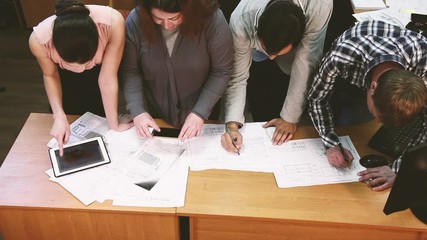 People work on a project in an office. top view