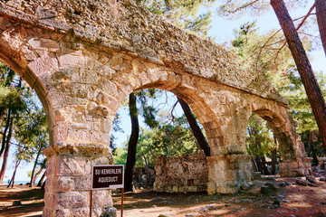 Travel and architecture. Ancient aqueduct in antique town Phaselis, Turkey.