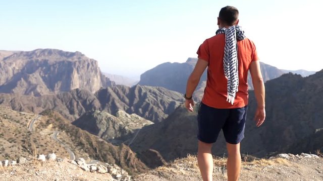 Young man admire canyon view in mountains, super slow motion 240fps
