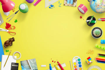 Yellow school work desk with creative, fun items beside. Free space in middle for text.