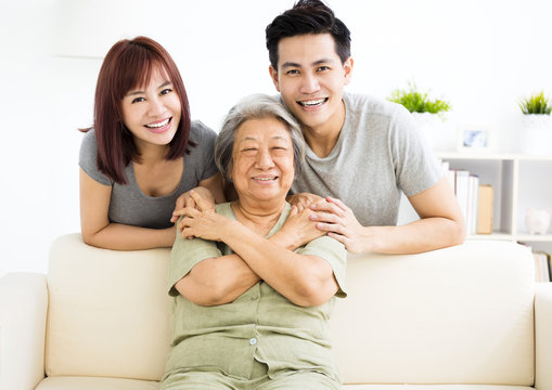 happy young couple with grandmother