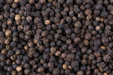 Black pepper seeds background.