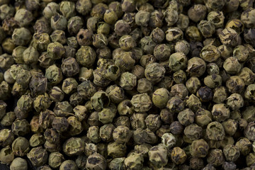 Green peppercorns background.