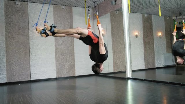 A man performs exercises alfagraviti in the studio 4k