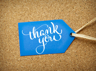 blue sticker sale on the cork background and text Thank you. Calligraphy lettering hand draw