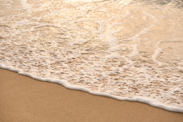 Fototapeta na wymiar Ocean waves exhausted on the beach in the morning