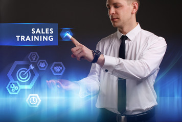 Business, Technology, Internet and network concept. Young businessman working on a virtual screen of the future and sees the inscription: Sales training