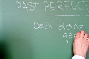 Teacher writing on a class board