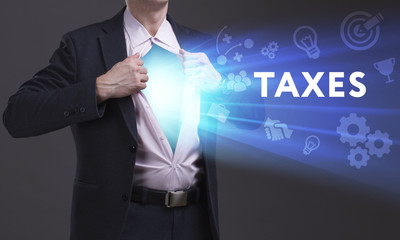 Business, Technology, Internet and network concept. Young businessman shows the word: Taxes