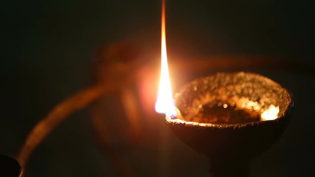Candle flame close-up in the Indian Temple on a Religious Festival Diwali. Oil Lamp