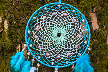 Dreamcatcher made of feathers, leather, beads, and ropes