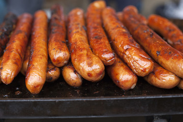Hotdog sausages cooking on a grill