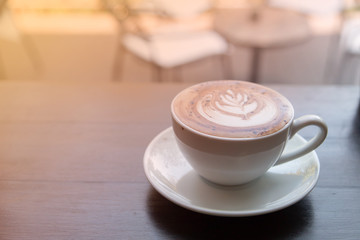 cup of coffee on wooden counter in cafe