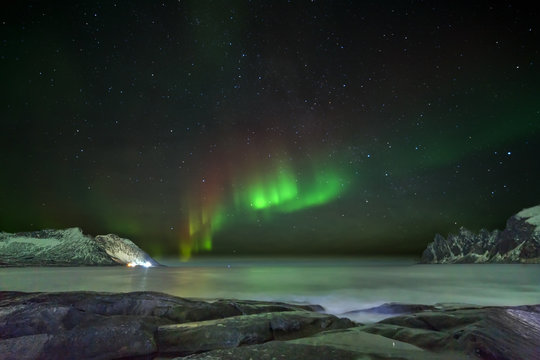 Aurora borealis (Polar lights). View to Steinfjord on Senja island (Oksan on Background) - Lofoten islands, Norway