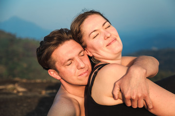 Loving couple on top of a mountain.
