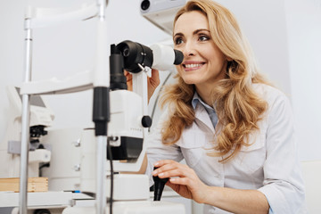 Fototapeta premium Excited young specialist employing professional equipment