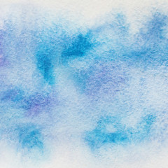 Hand painted blue watercolor background on paper texture.