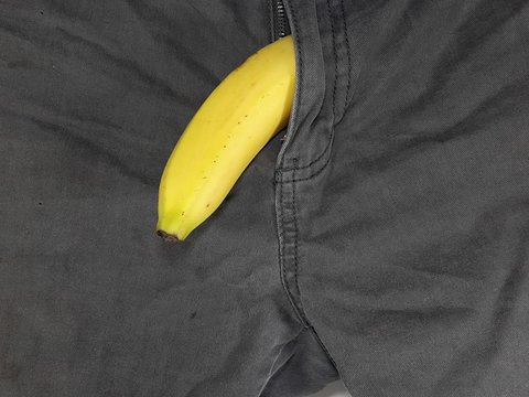 Men's health medical concept. Banana on a pant symbolic men's private part health problem