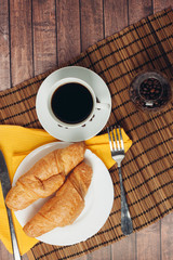 breakfast, a cup of coffee and croissants