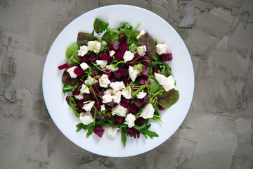 Beet salad, greens and ricotta cheese. Top view.