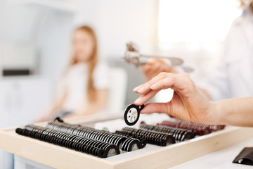 Scrupulous neat specialist taking a trial lens