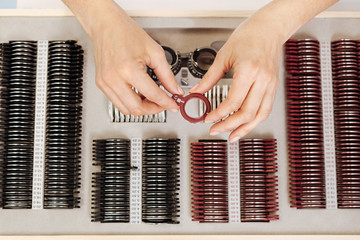Precise experienced ophthalmologist examining the lenses
