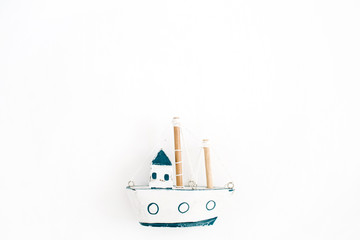 Wooden handmade toy boat on white background. Flat lay, top view