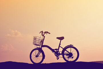 Silhouette of bicycle on nature with the sky sunset