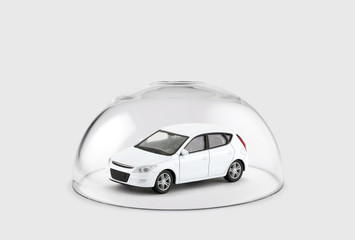 White car protected under a glass dome