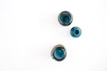 Three blue stylish jars on white background. Top view minimal decoration concept.